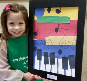 Young Abrakadoodle student in Georgia proudly shows her art inspired by Leonor Brazao.