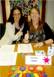 Rosemarie Hartnett (left), President of Abrakadoodle, welcomes new Raleight, NC franchisee Pat Schon, sealing her contract with thumb prints! 