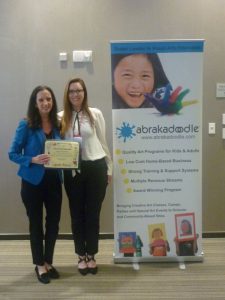 Rosemarie Hartnett, President of Abrakadoodle presents Arts for All Award to Margaret Cornwell.