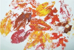 Dip the shells or leaves in paint. Press and print them on paper leaving texture marks.  